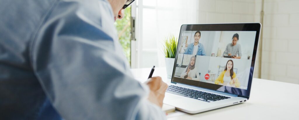 A remote employee on a video call with colleagues